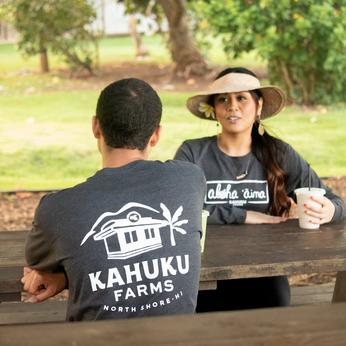 man and woman modeling front and back charcoal grey kahuku farms long sleeve shirt