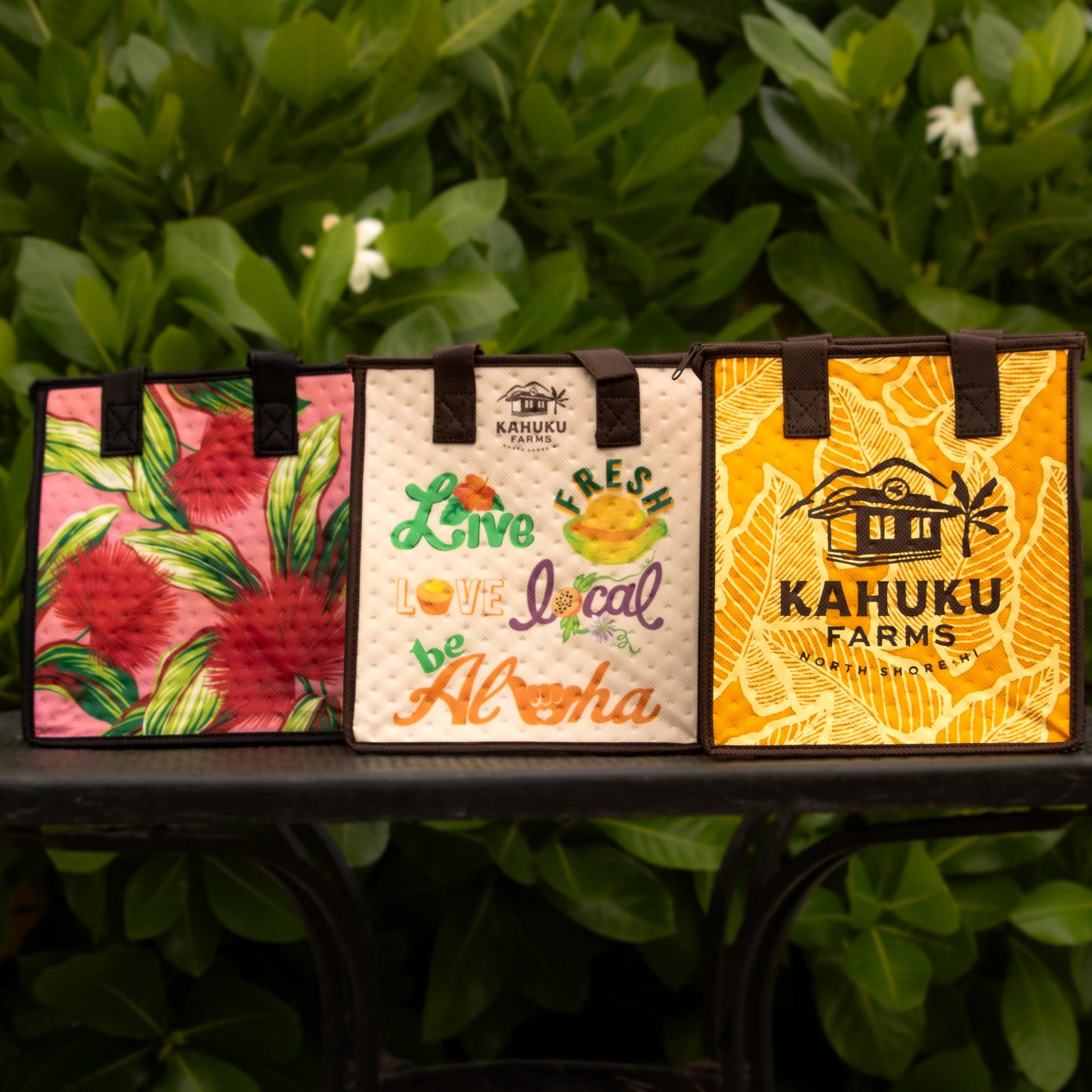 3 thermal totes: pink floral, live fresh love local be aloha, and kahuku farms logo