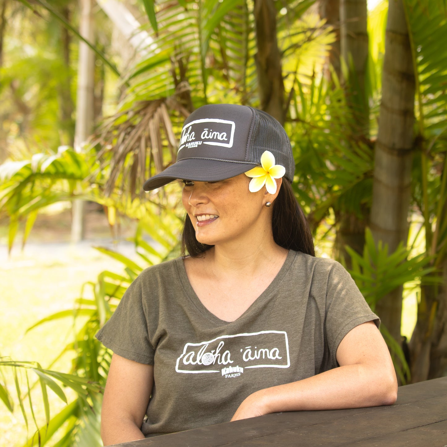 woman wearing kahuku farms aloha 'aina hat