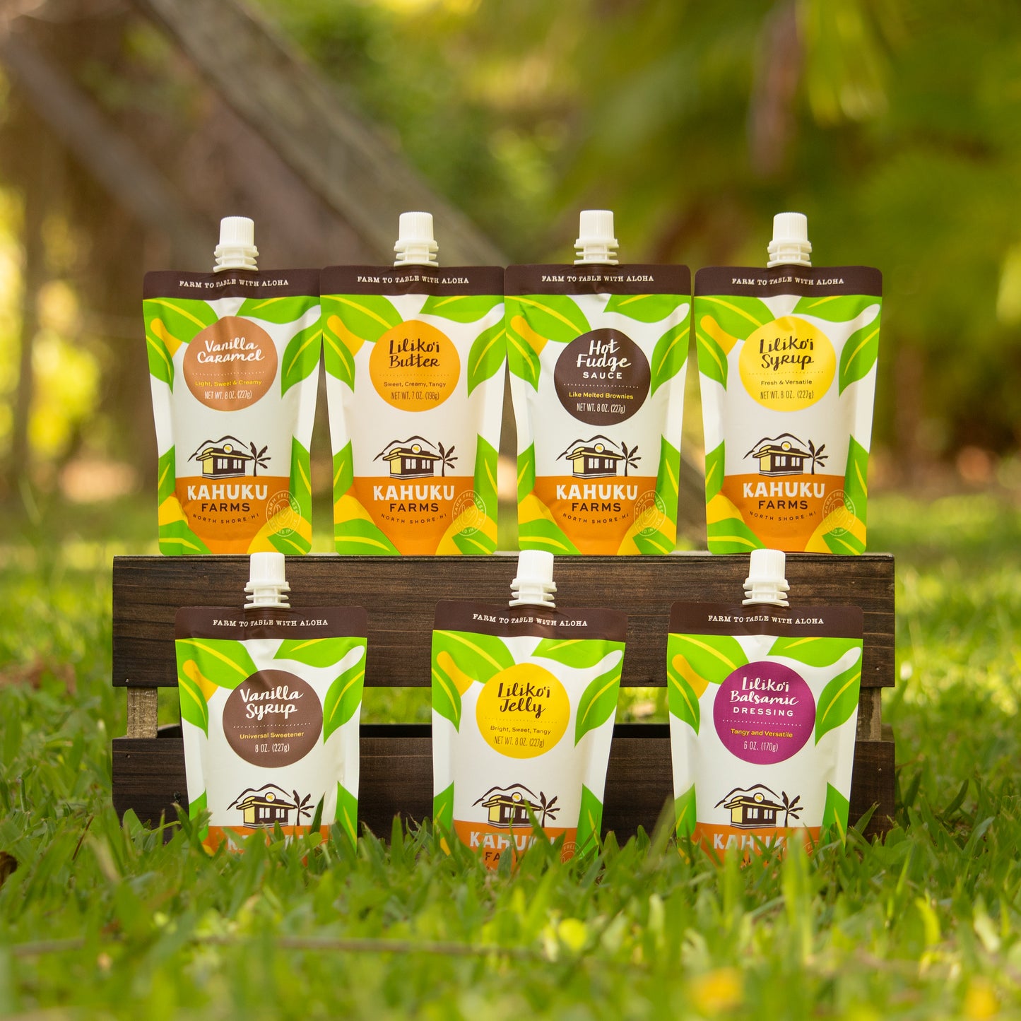medley of products in spouted pouches: vanilla caramel, liliko'i butter, hot fudge, liliko'i syrup, vanilla syrup, liliko'i jelly, liliko'i balsamic dressing