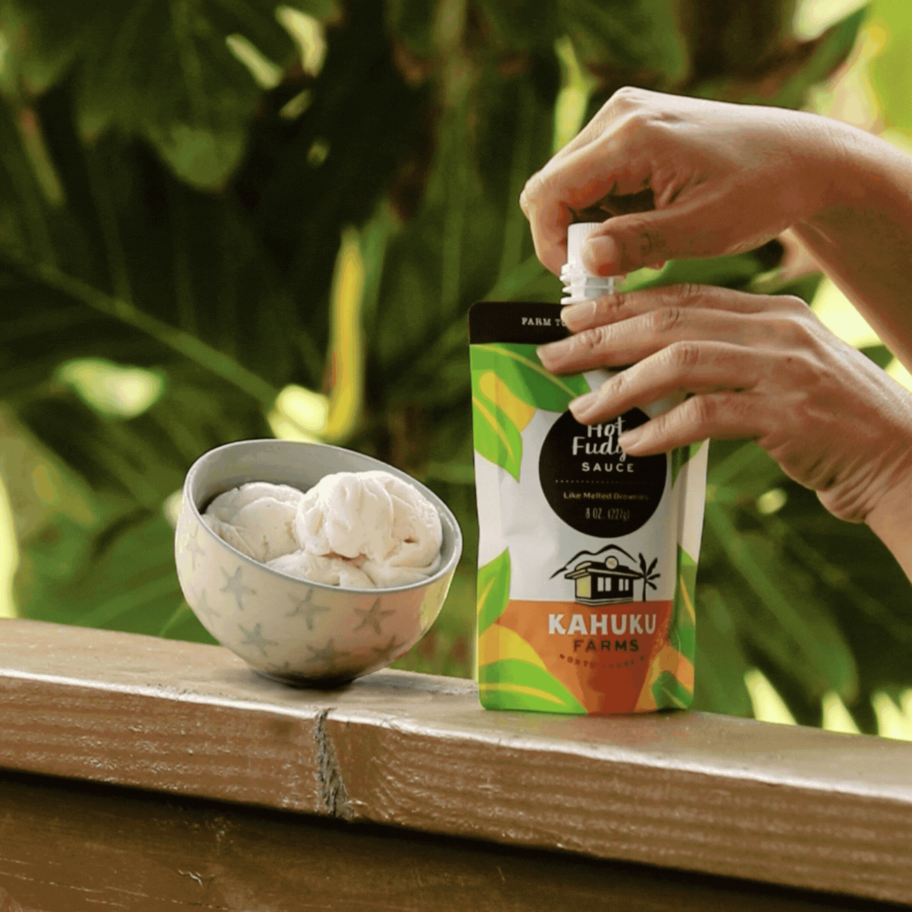 pouring hot fudge onto ice cream